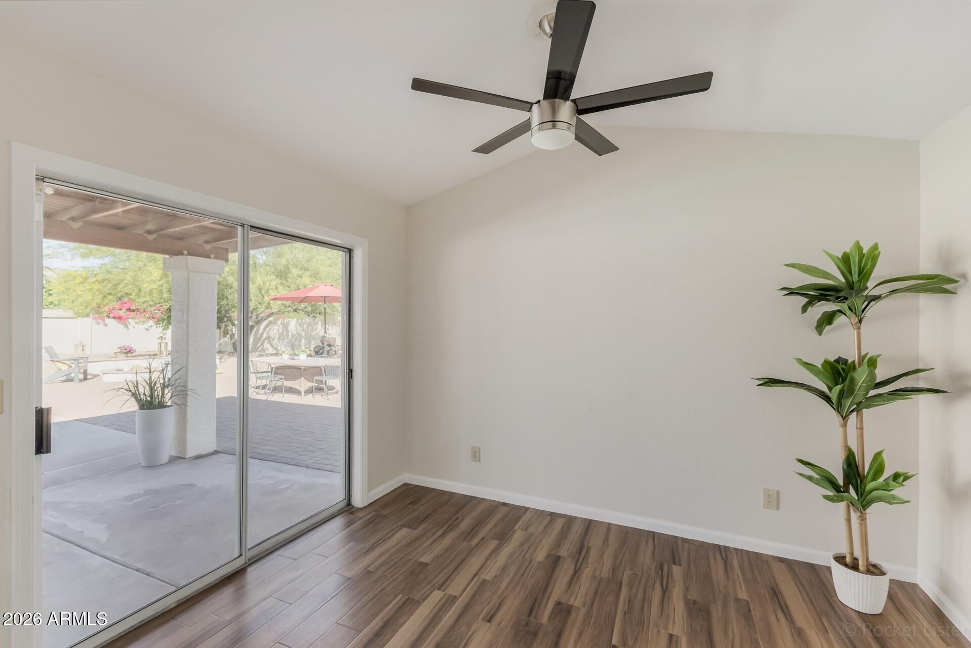 5116 East Wethersfield Road Scottsdale, AZ 85254 - Photo 18 of 53 a view of a room with wooden floor and a potted plant