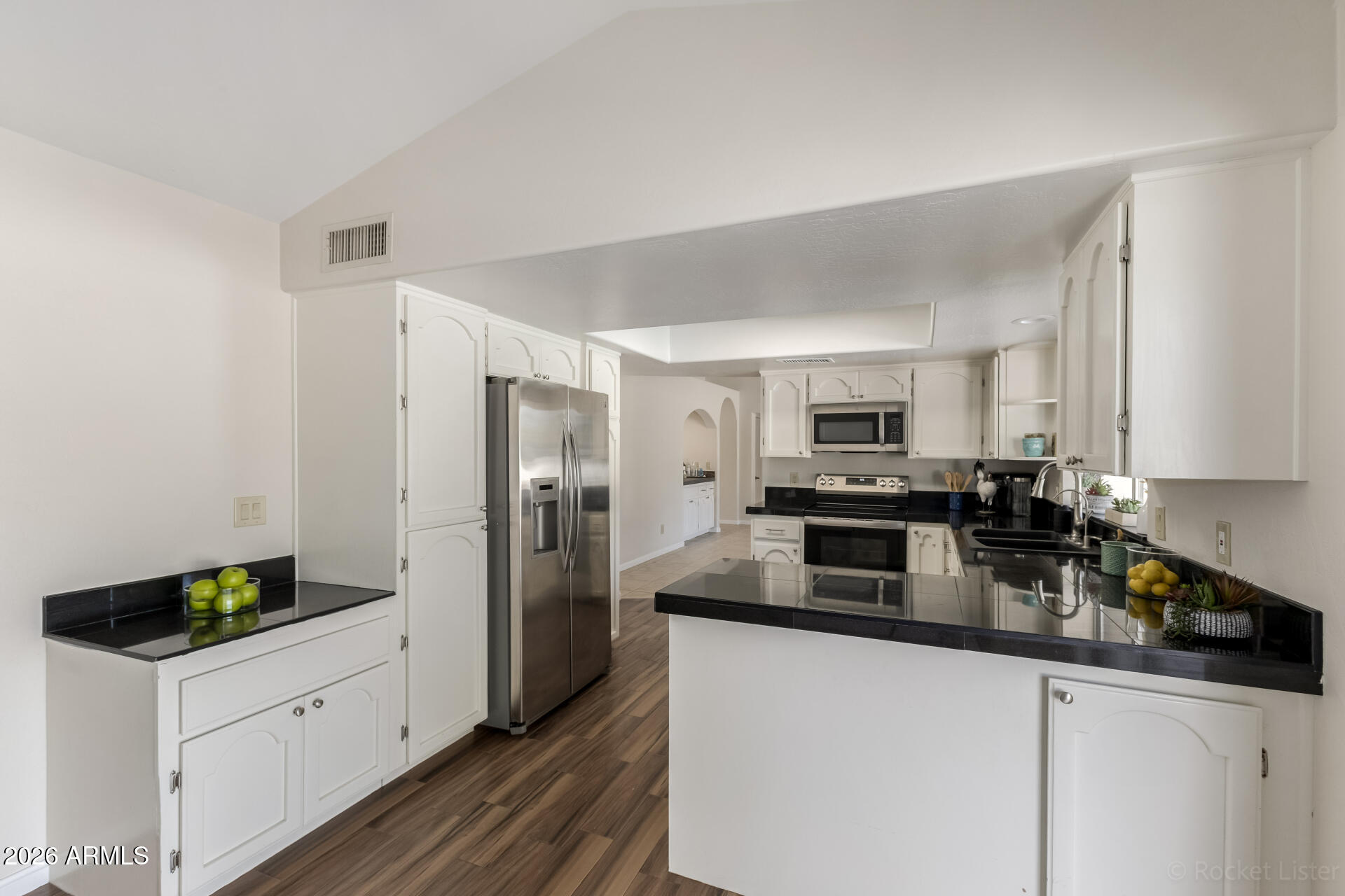 5116 East Wethersfield Road Scottsdale, AZ 85254 - Photo 19 of 53 a kitchen with a refrigerator and a stove top oven