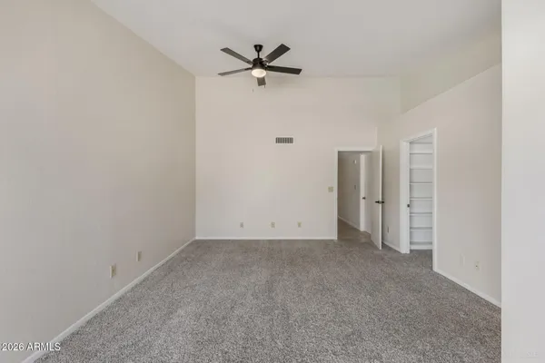 an empty room with windows and closet