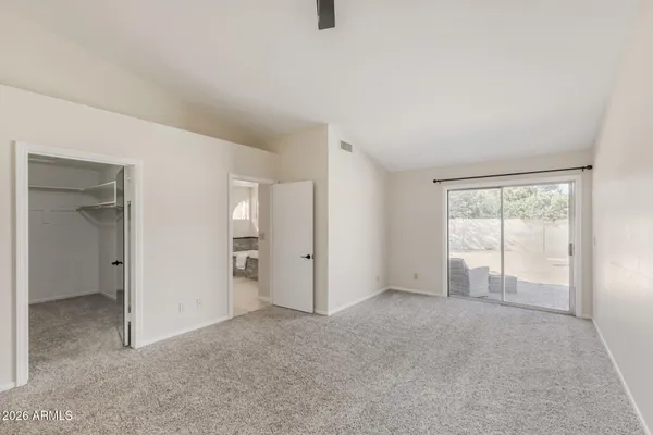 a large white bathroom with a sink vanity and mirror