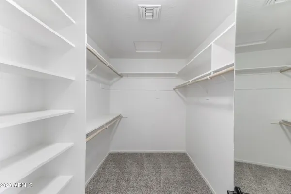 a large white bathroom with a sink a toilet and shower
