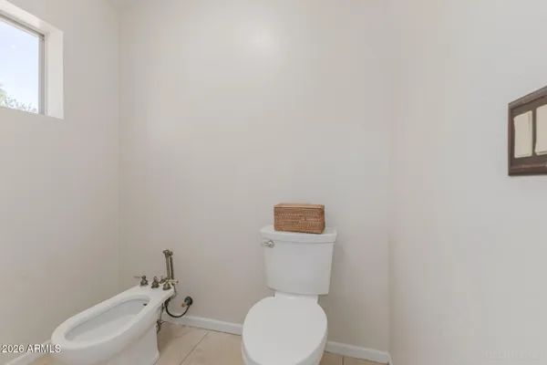 an empty room with a ceiling fan and windows