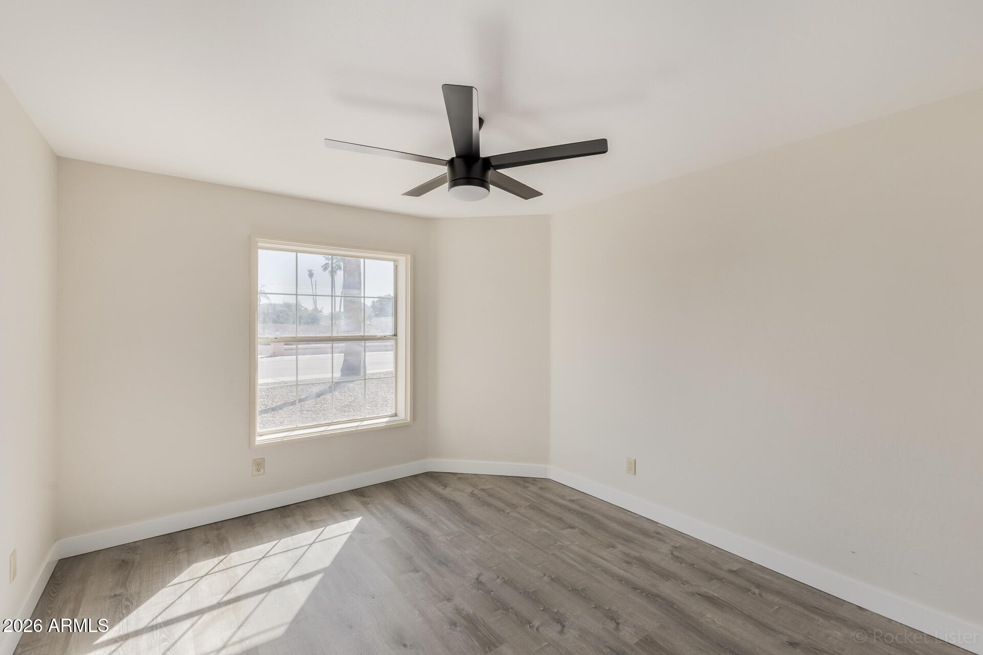 5116 East Wethersfield Road Scottsdale, AZ 85254 - Photo 33 of 53 an empty room with a window and a fan