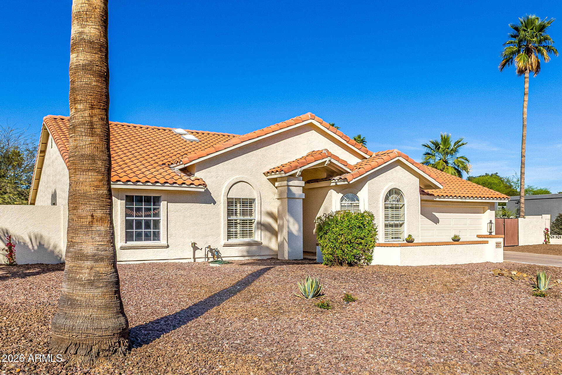 5116 East Wethersfield Road Scottsdale, AZ 85254 - Photo 3 of 53 a front view of a house with a yard and garage