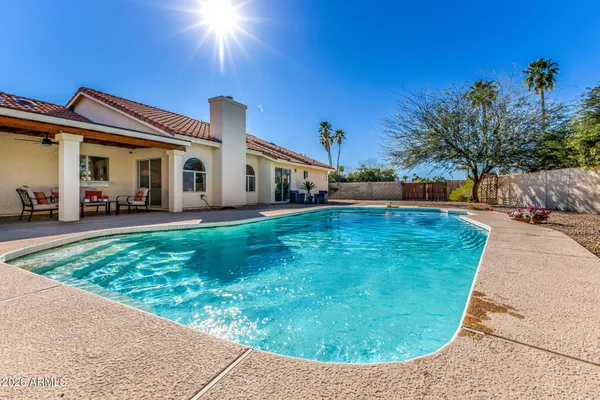 a view of a backyard with a patio and fire pit