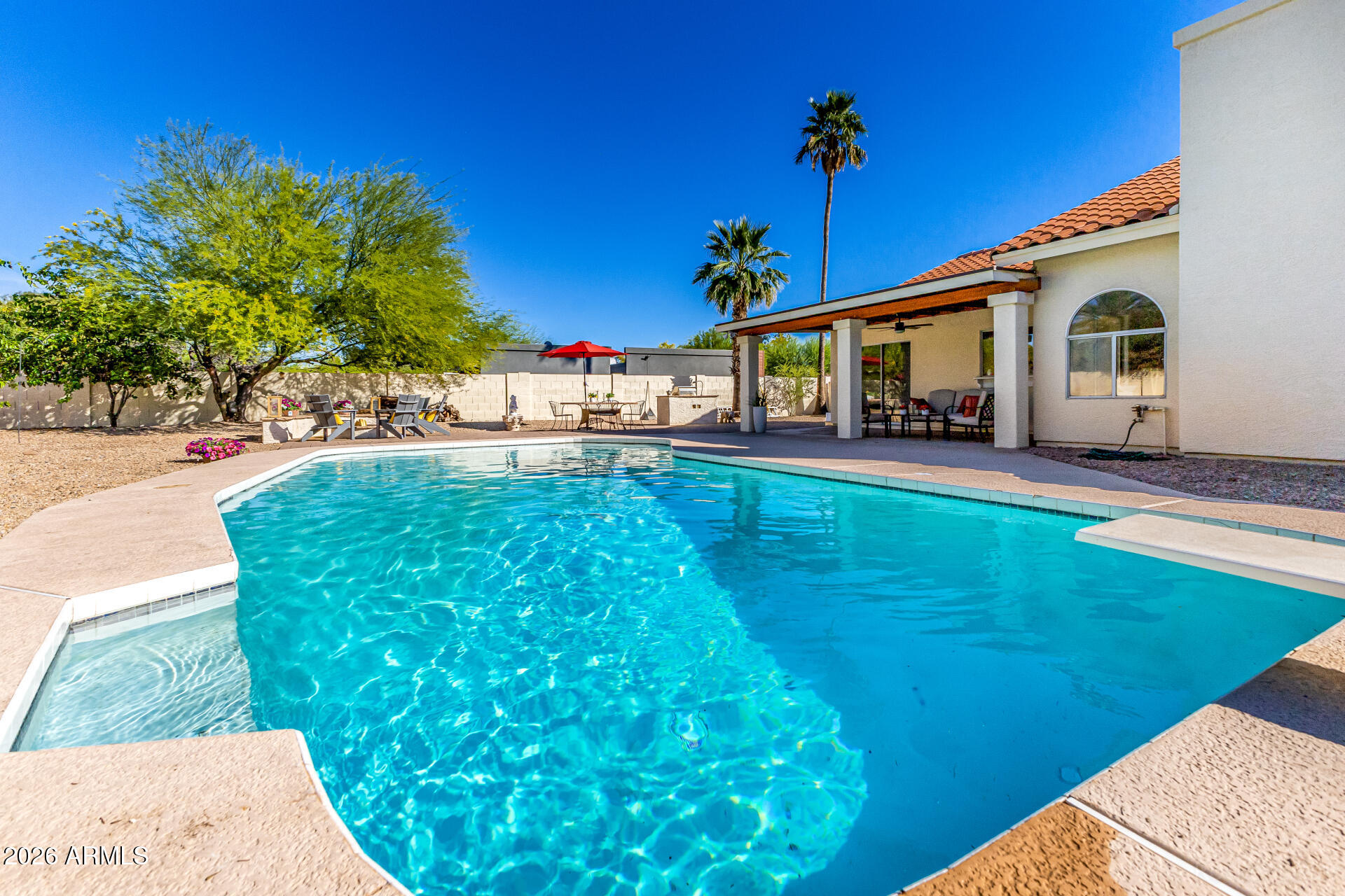 5116 East Wethersfield Road Scottsdale, AZ 85254 - Photo 41 of 53 a view of a house with a yard porch and sitting area