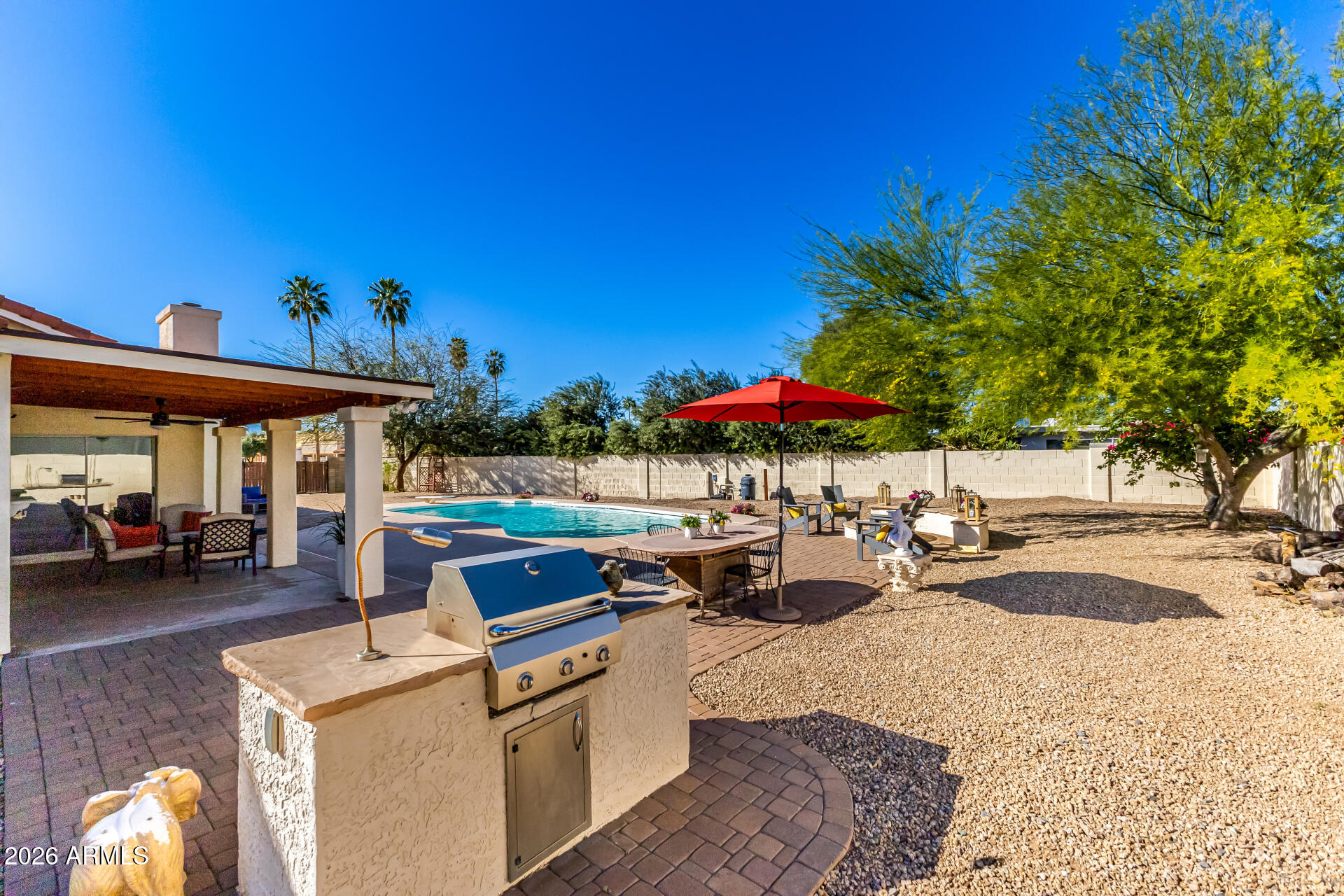 5116 East Wethersfield Road Scottsdale, AZ 85254 - Photo 42 of 53 a view of a backyard with a patio and fire pit