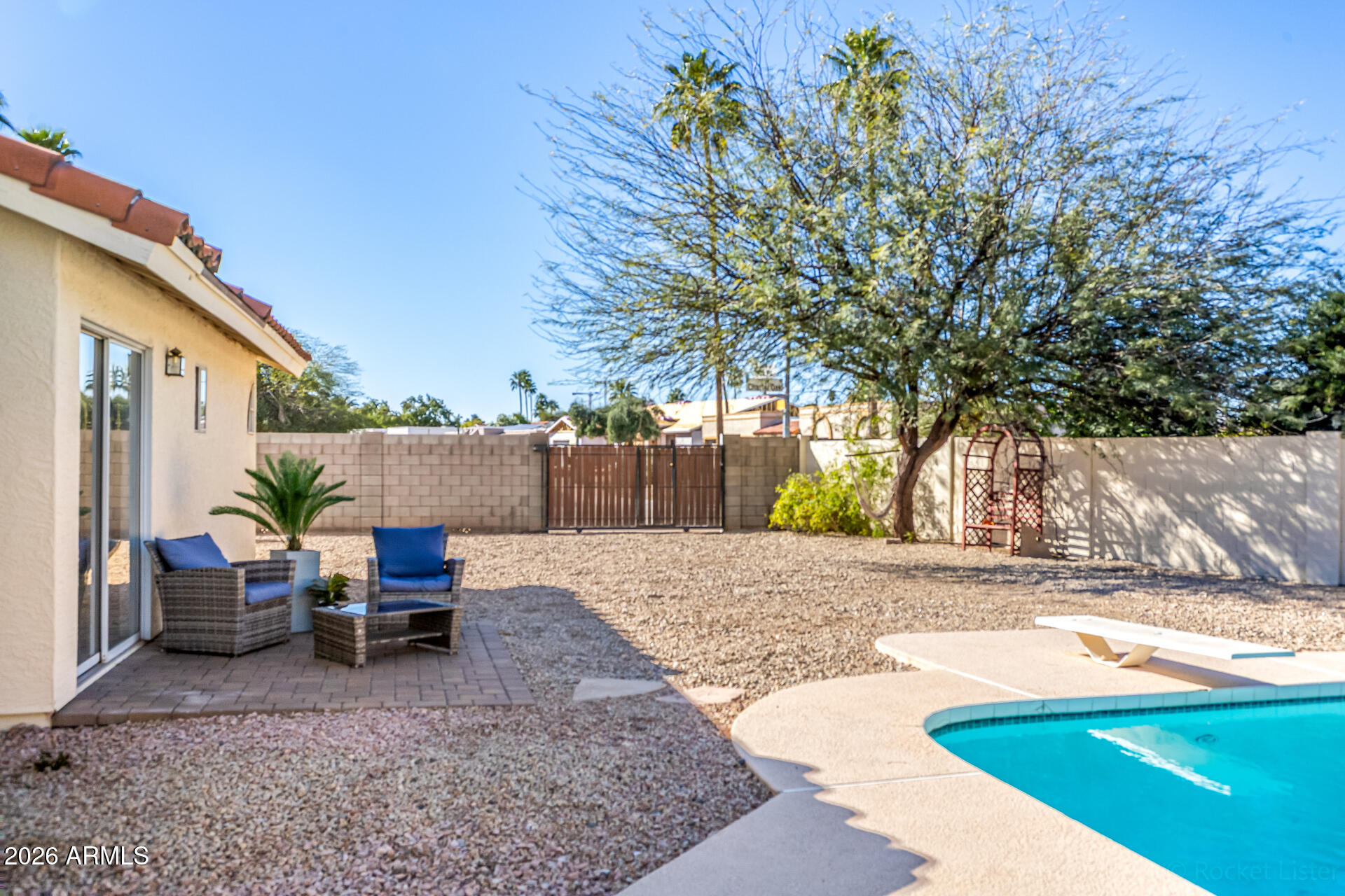 5116 East Wethersfield Road Scottsdale, AZ 85254 - Photo 43 of 53 a view of backyard with outdoor seating and trees