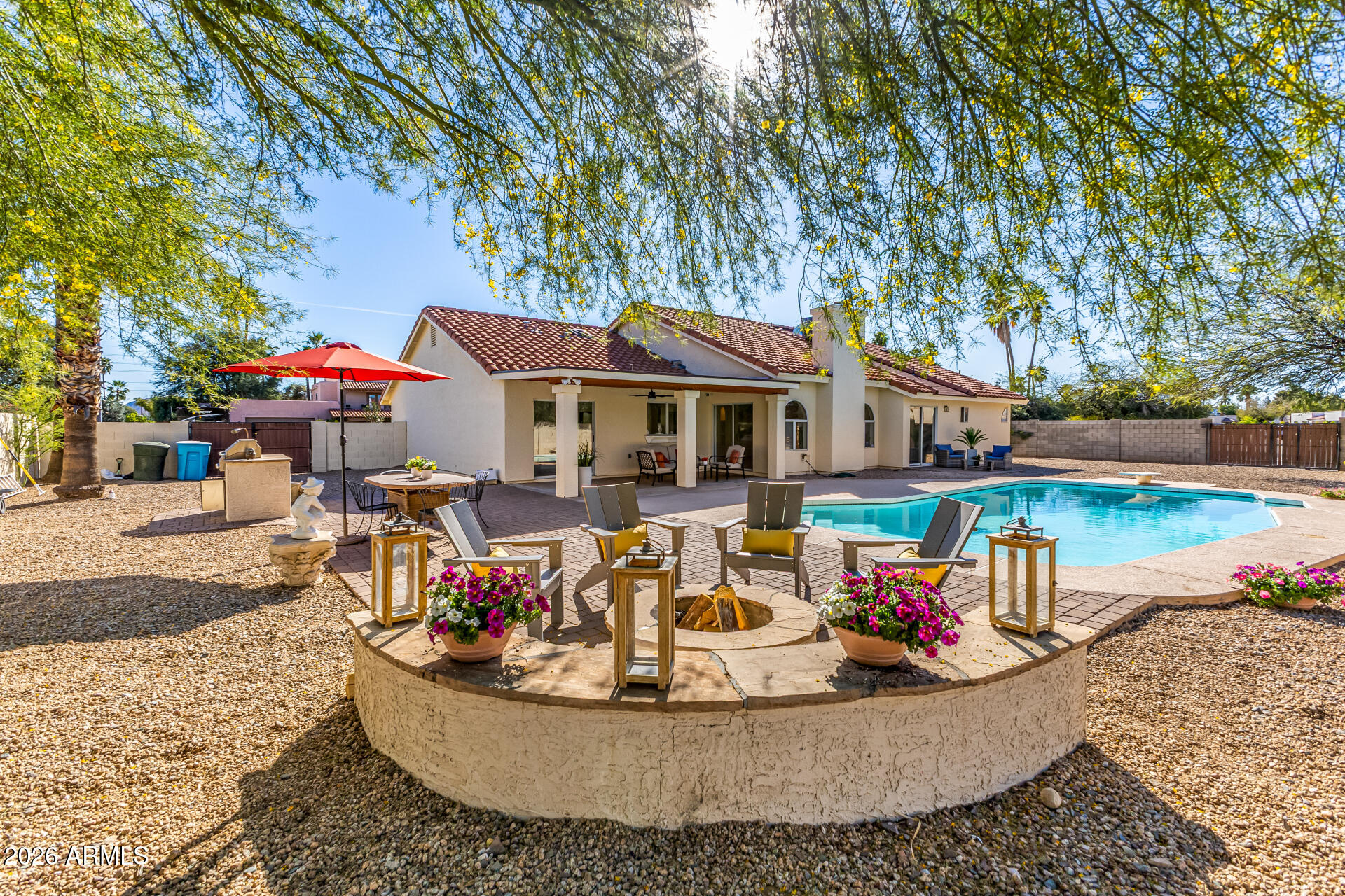 5116 East Wethersfield Road Scottsdale, AZ 85254 - Photo 4 of 53 a view of a house with swimming pool and sitting area