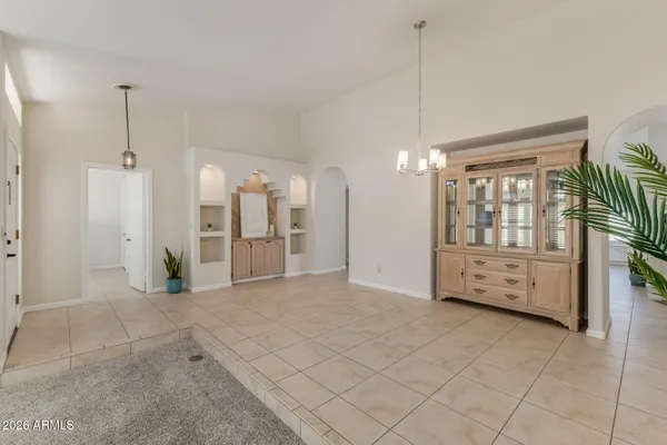 an empty room with fireplace and windows
