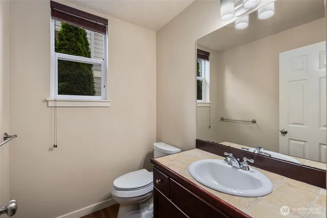 a bathroom with a sink toilet and a mirror