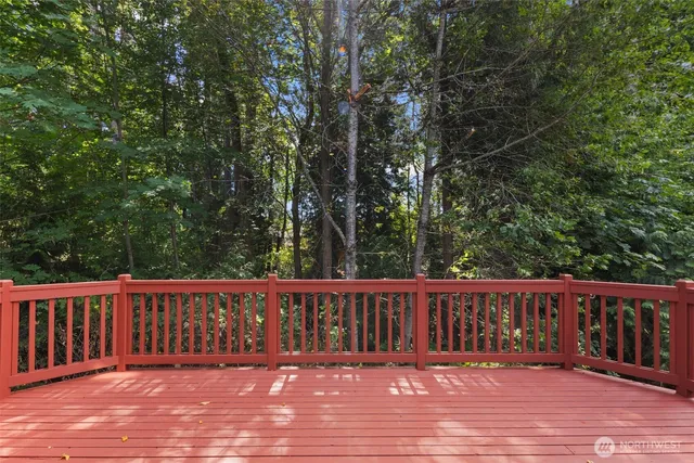 a view of balcony with wooden floor and fence