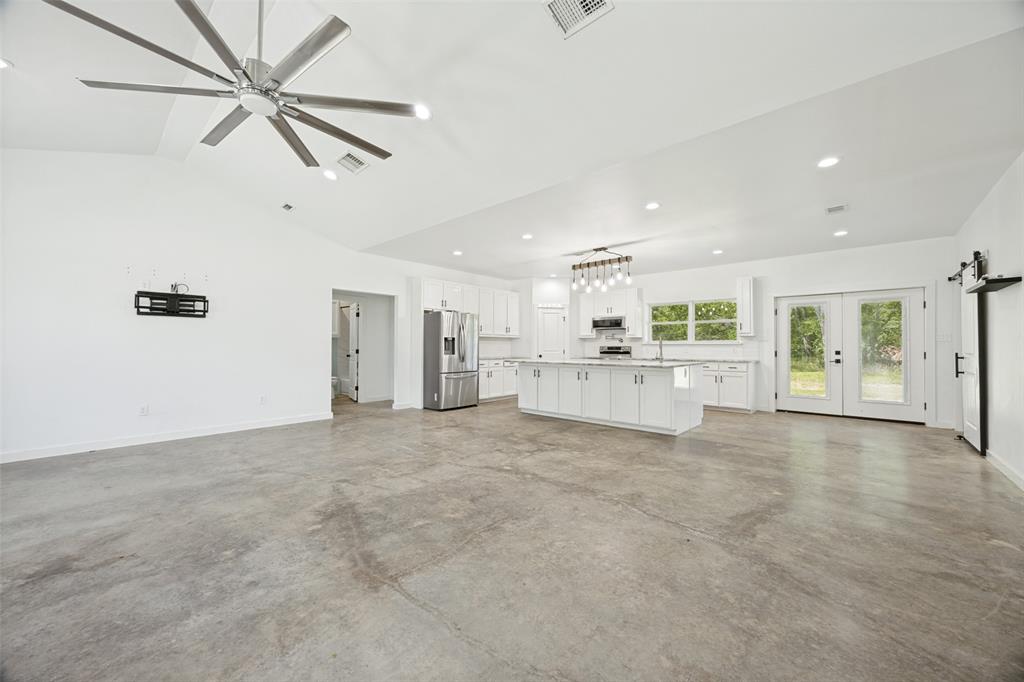 822 Private Road 7370 Point, TX 75472 - Photo 11 of 30 Open-concept living space featuring vaulted ceilings, polished concrete flooring, recessed lighting, and a modern ceiling fan