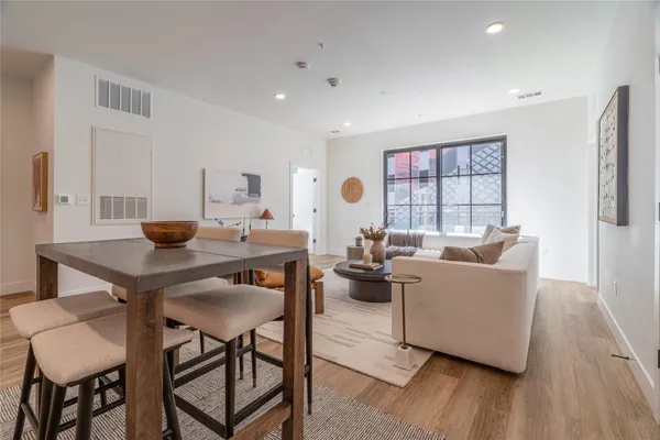 a living room with furniture and a wooden floor