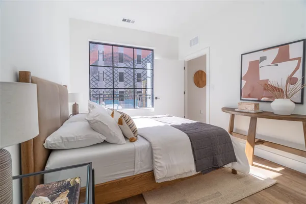 a bedroom with a bed and a painting on the wall