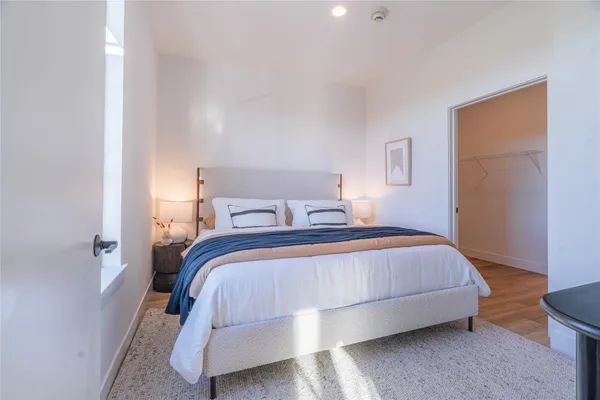 a bedroom with a bed and a night stand