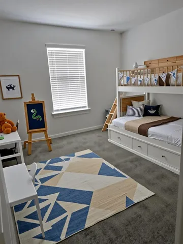 a bedroom with a bed and a table in it