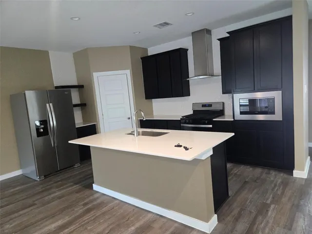 a kitchen with a refrigerator and a sink