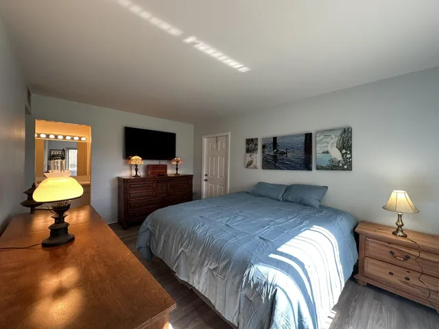 a bedroom with a bed and a lamp on table