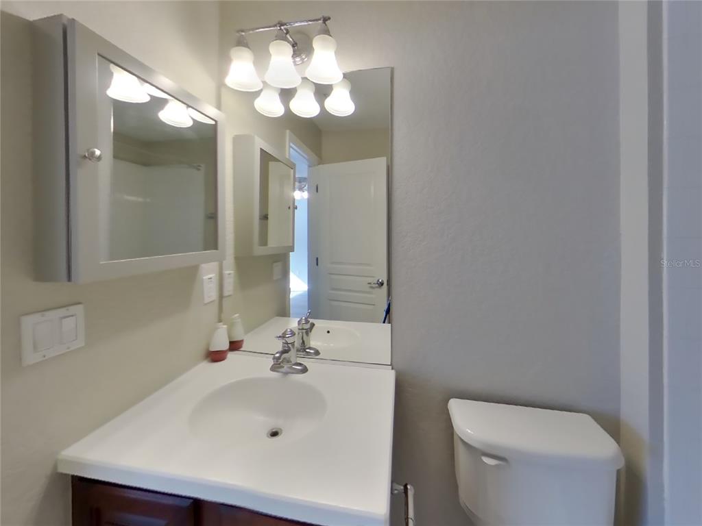 Undisclosed Address Windermere, FL 34786 - Photo 11 of 19 a bathroom with a sink a toilet and a mirror