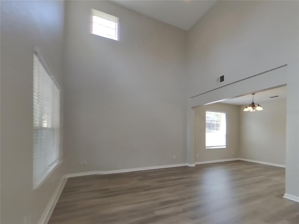 Undisclosed Address Windermere, FL 34786 - Photo 16 of 19 a view of empty room with window and wooden floor