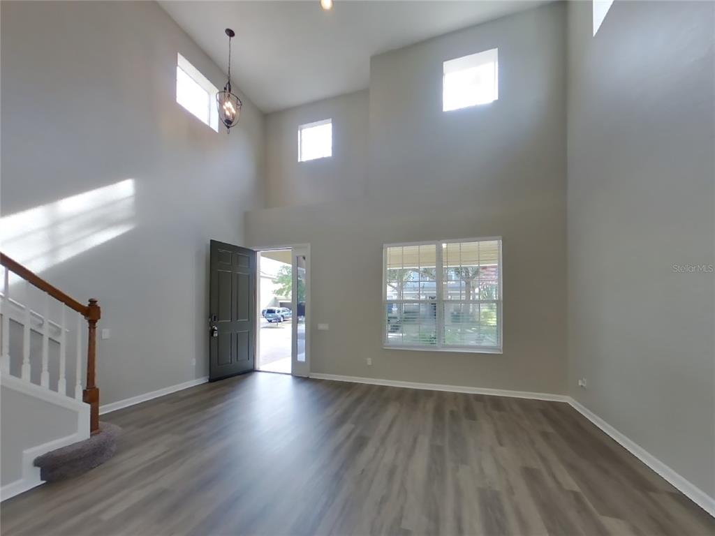 Undisclosed Address Windermere, FL 34786 - Photo 17 of 19 wooden floor in an empty room with a window