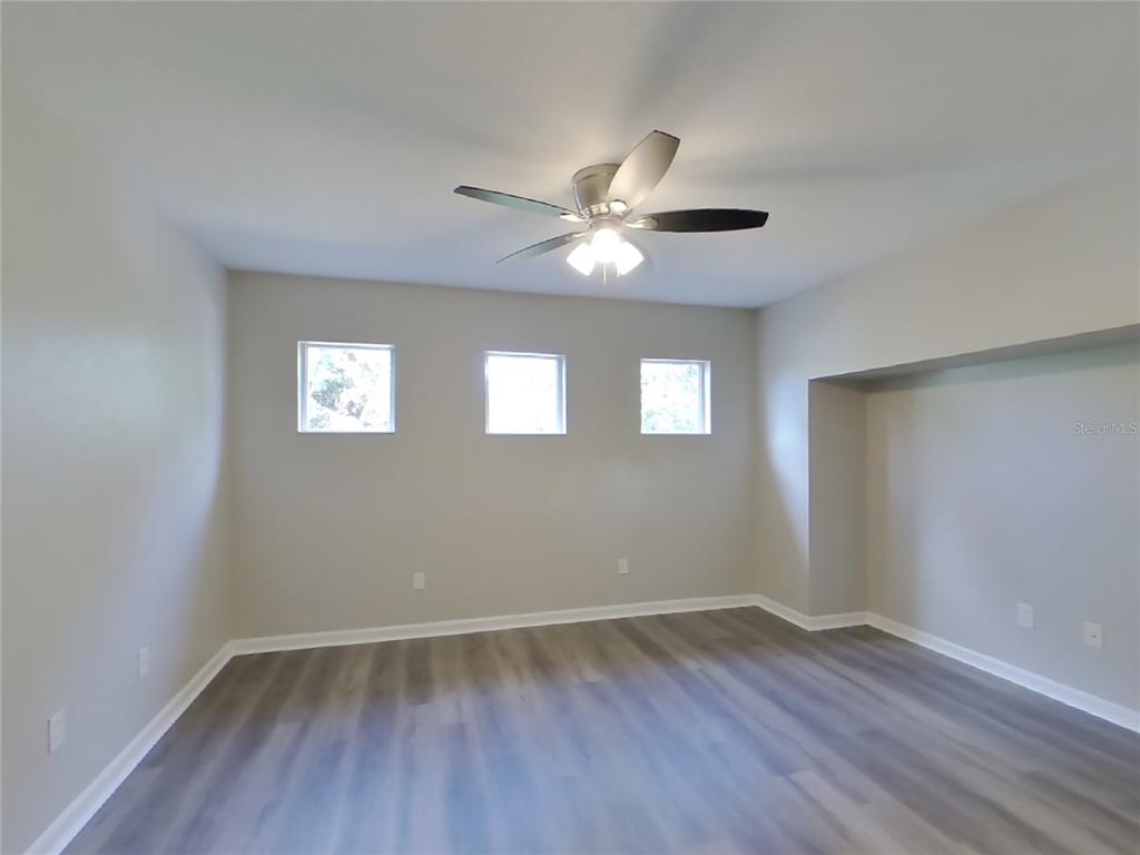 Undisclosed Address Windermere, FL 34786 - Photo 18 of 19 wooden floor in an empty room with a window