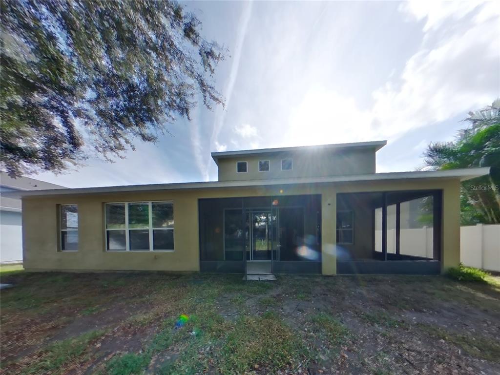 Undisclosed Address Windermere, FL 34786 - Photo 19 of 19 a view of a brick house with a large window and large tree