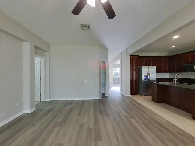 a view of kitchen with sink microwave and refrigerator