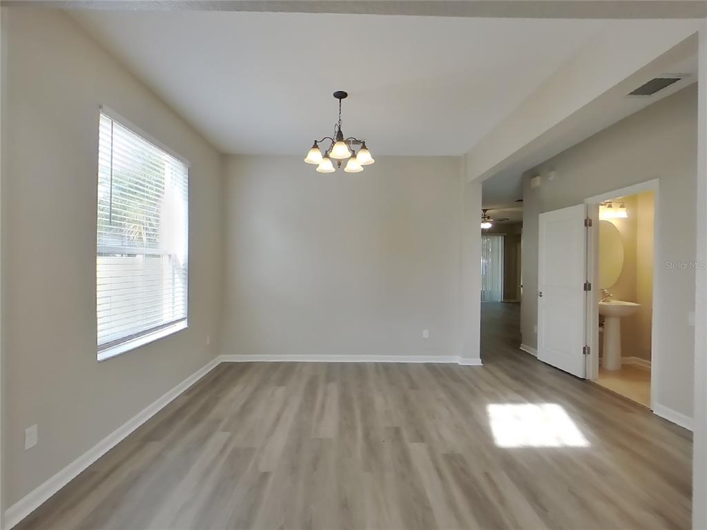 Undisclosed Address Windermere, FL 34786 - Photo 4 of 19 an empty room with wooden floor and windows