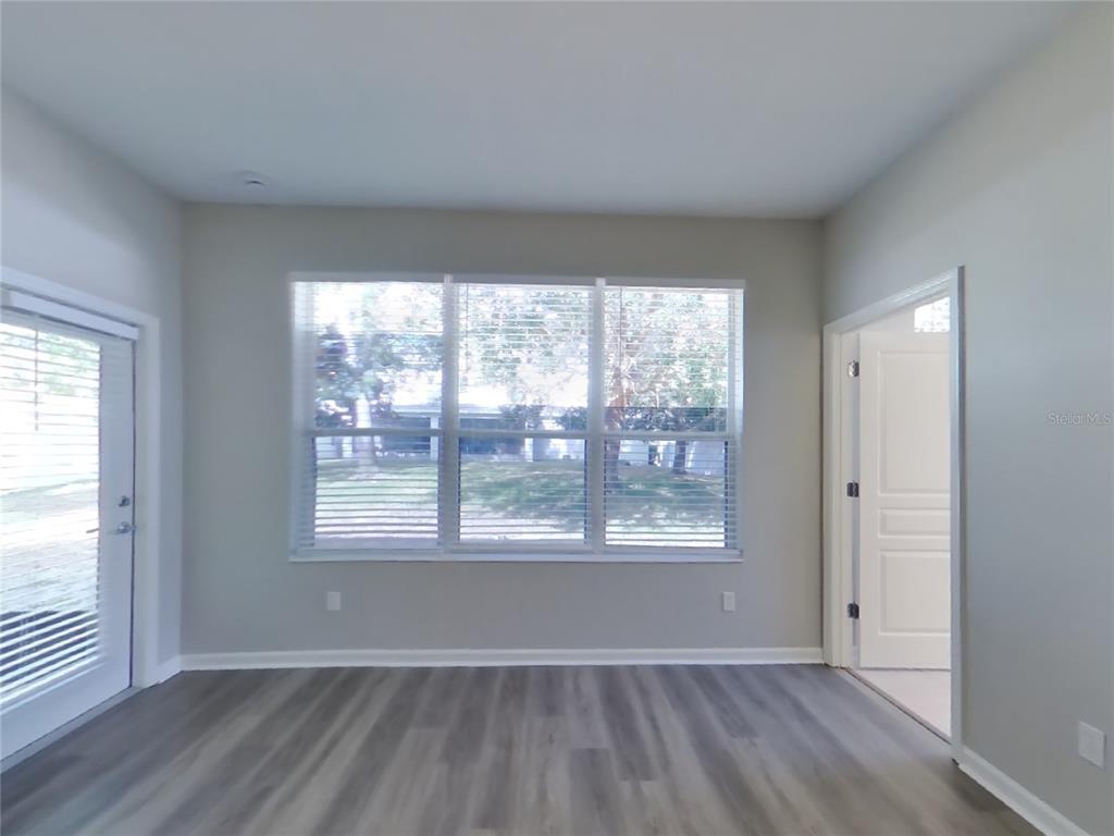 Undisclosed Address Windermere, FL 34786 - Photo 6 of 19 an empty room with wooden floor and windows