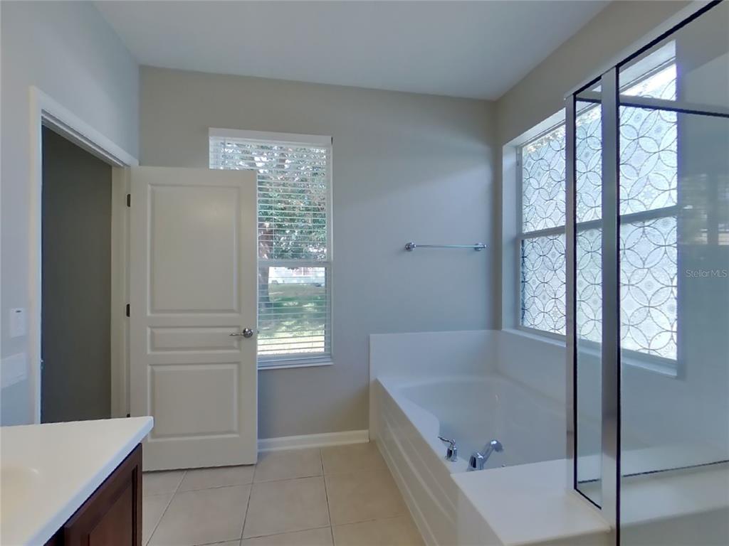 Undisclosed Address Windermere, FL 34786 - Photo 7 of 19 a bathroom with a bathtub and shower
