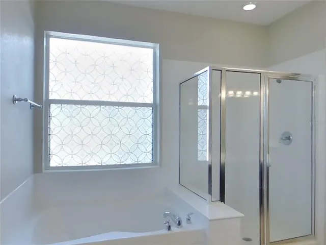 a bathroom with a bathtub and a shower