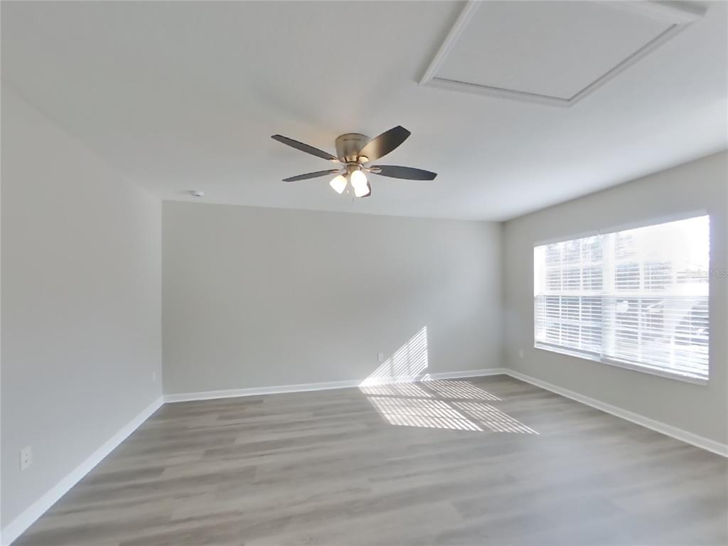 Undisclosed Address Windermere, FL 34786 - Photo 9 of 19 a view of an empty room with wooden floor and a window