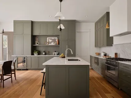 a kitchen with stainless steel appliances a sink dishwasher a stove top oven a refrigerator with island and chairs