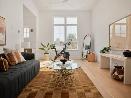a living room with furniture fireplace and a large window