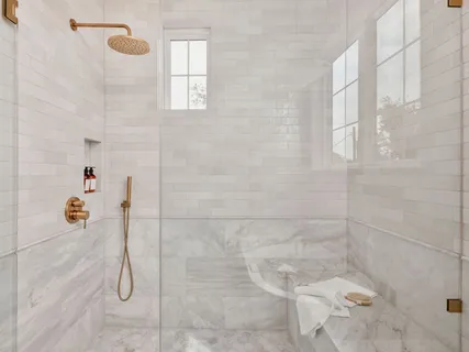 a bathroom with a granite countertop sink a toilet and mirror