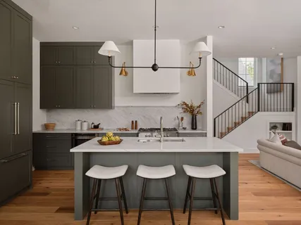 a kitchen with a dining table chairs and sink
