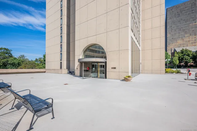 a view of building with yard and sitting area