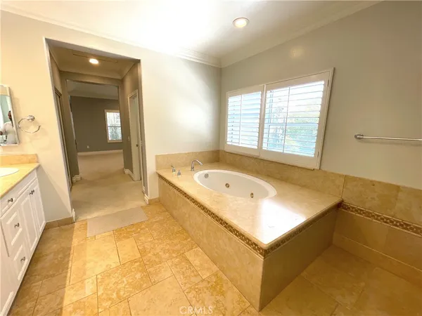 a bathroom with a tub sink and mirror