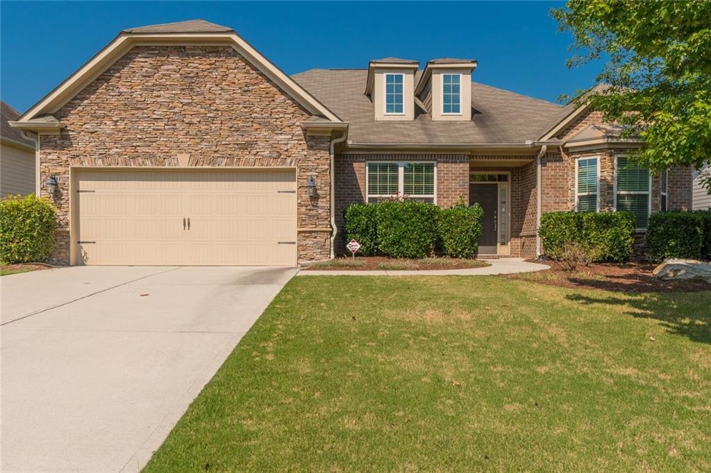 Beautiful ranch home with bay window, brick front with lovely stacked stone accents.