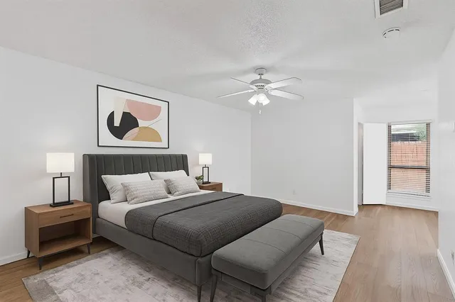 a bedroom with bed and a chandelier