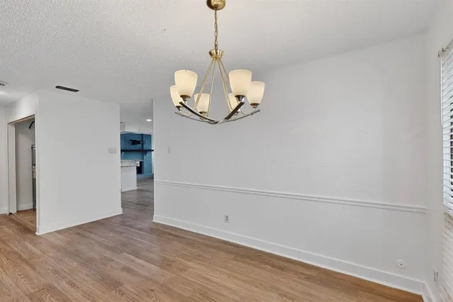 a view of a room with wooden floor and staircase
