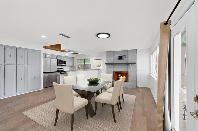 a dining room with furniture and wooden floor