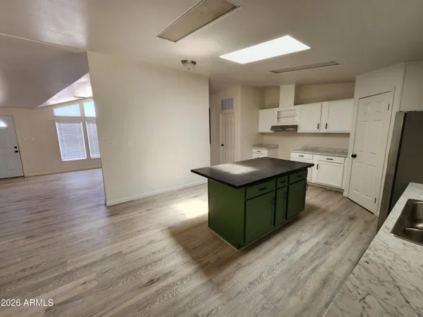a kitchen with granite countertop a sink appliances and cabinets