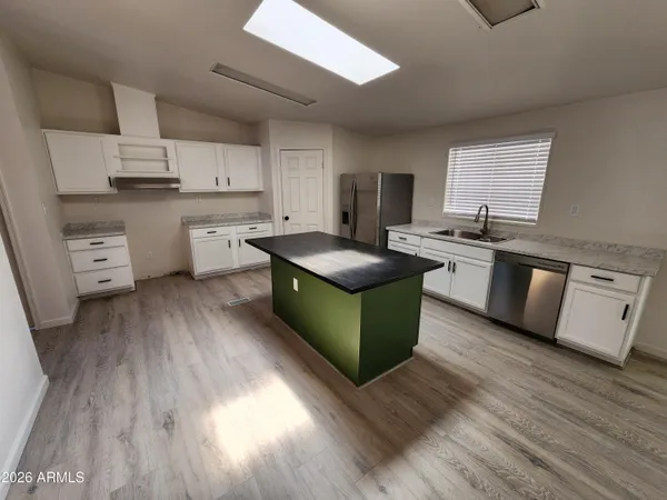 a kitchen with stainless steel appliances granite countertop a sink and cabinets