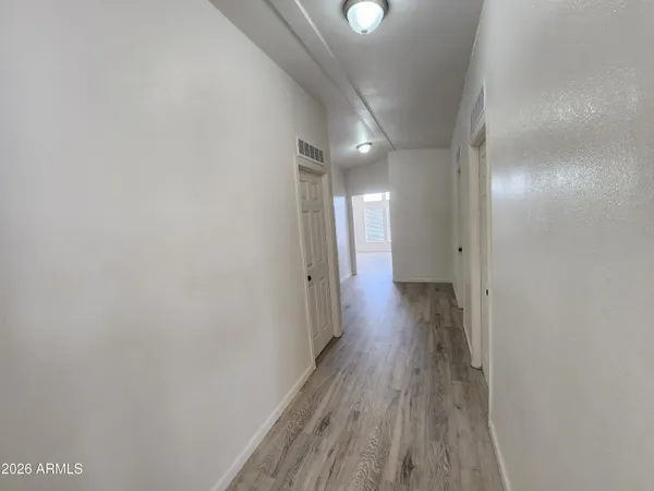 a view of hallway with wooden floor
