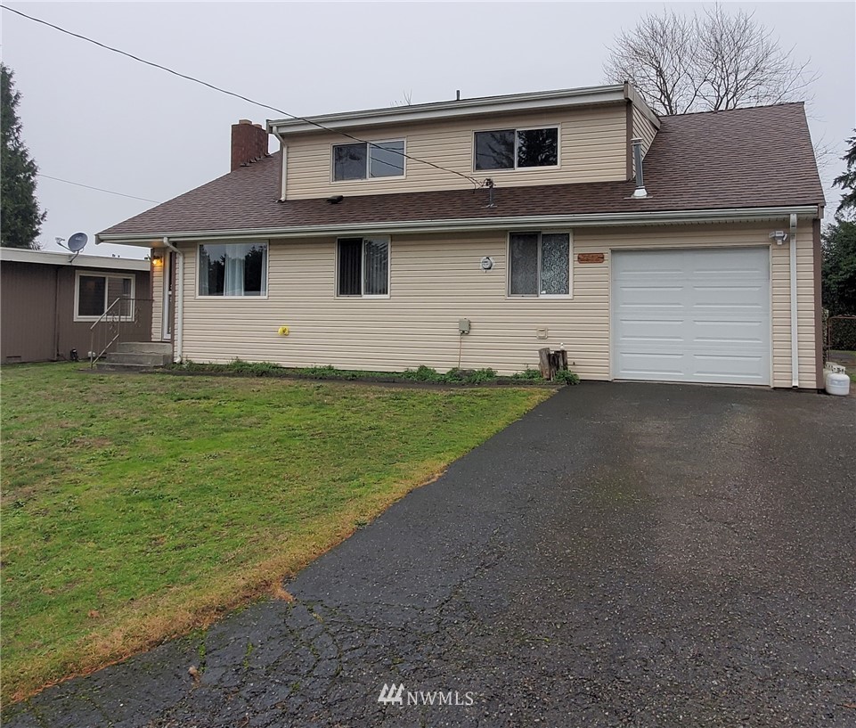 2412 Northeast 23rd Street Renton, WA 98056 - Photo 3 of 33 a front view of a house with a yard