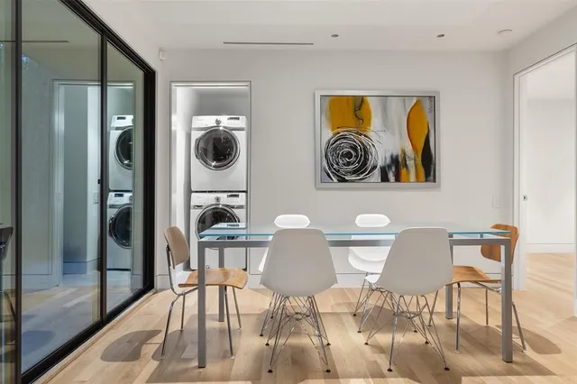 a view of a dining room with furniture and front view of a house