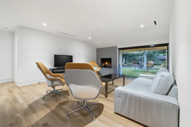 a living room with furniture and a floor to ceiling window